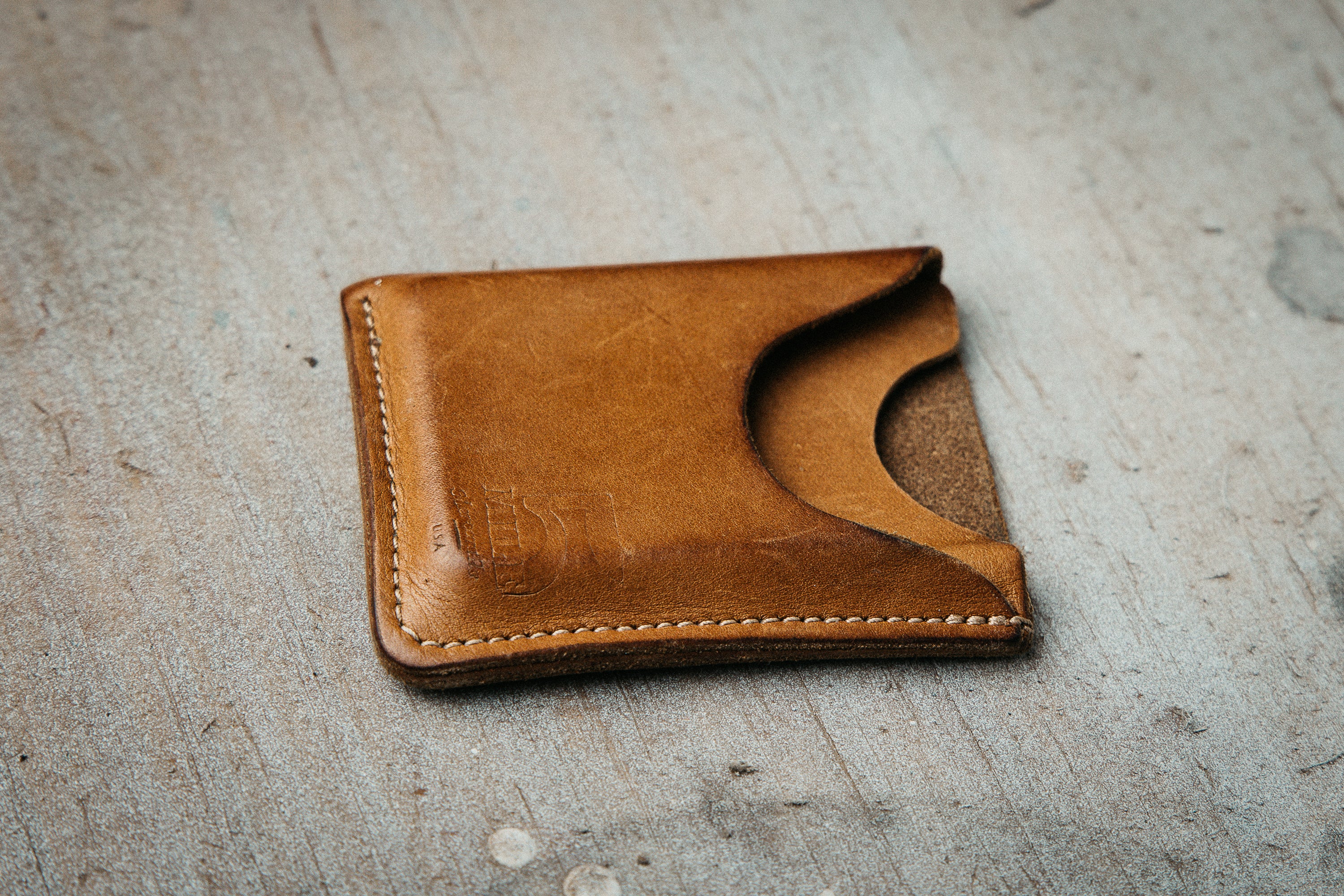Brown leather wallet on a textured surface