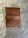 Pocket wallet with flap Brown flap closed on cutting table