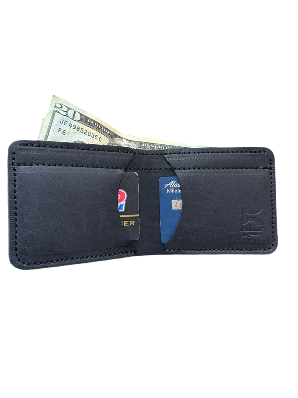 3 pocket bifold wallet black with cards and money on cutting table