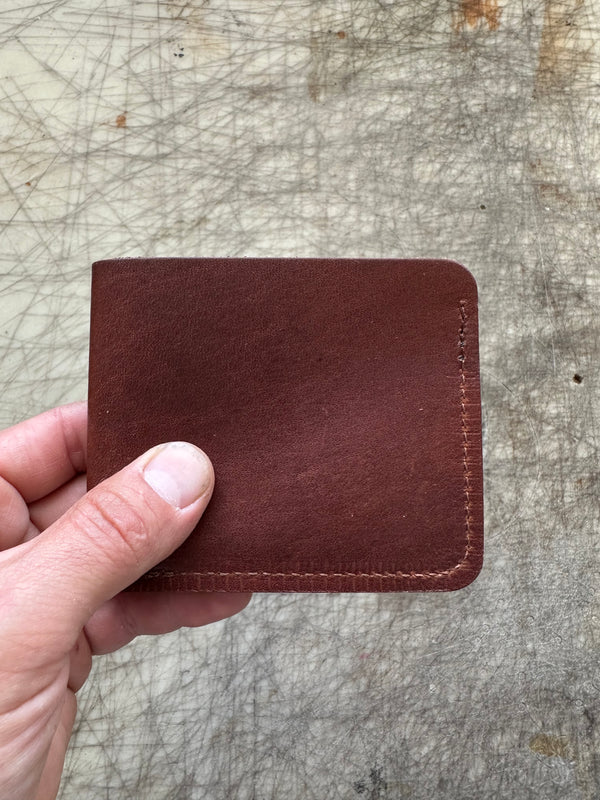 3 pocket bifold wallet brown folded in hand
