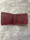 3 pocket bifold wallet brown on cutting table