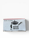 Box of Cross hand tacks on a white background