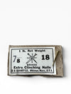Box of brass nails with a label on a white background
