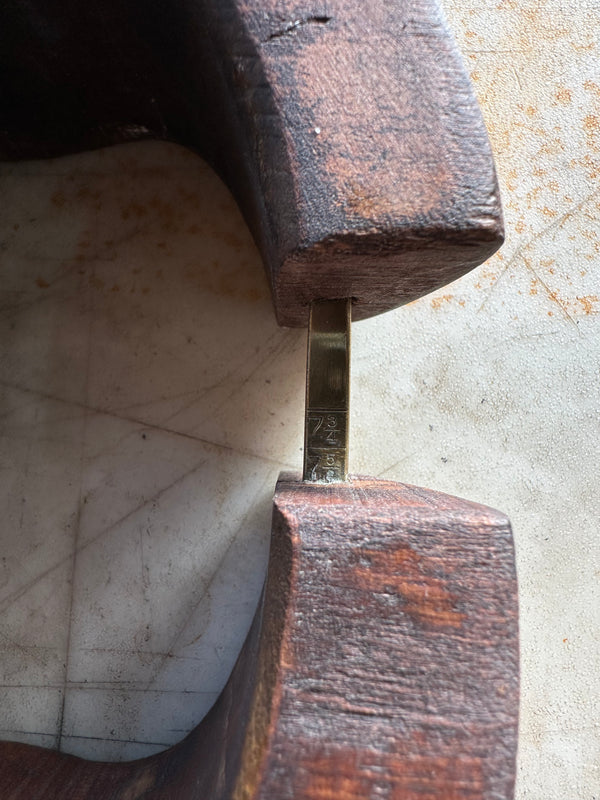 Antique hat stretcher zoomed in on brass scale