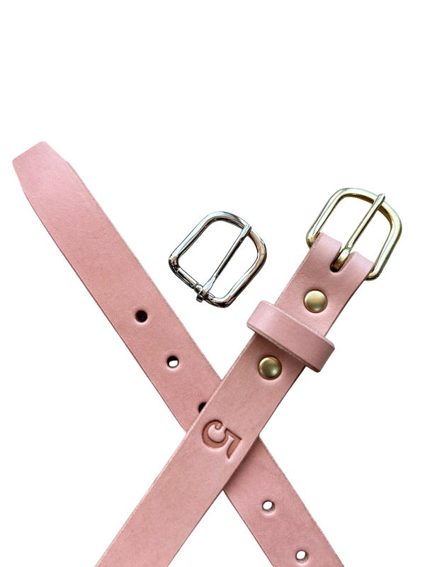 Pink leather belt with gold buckle on a white background