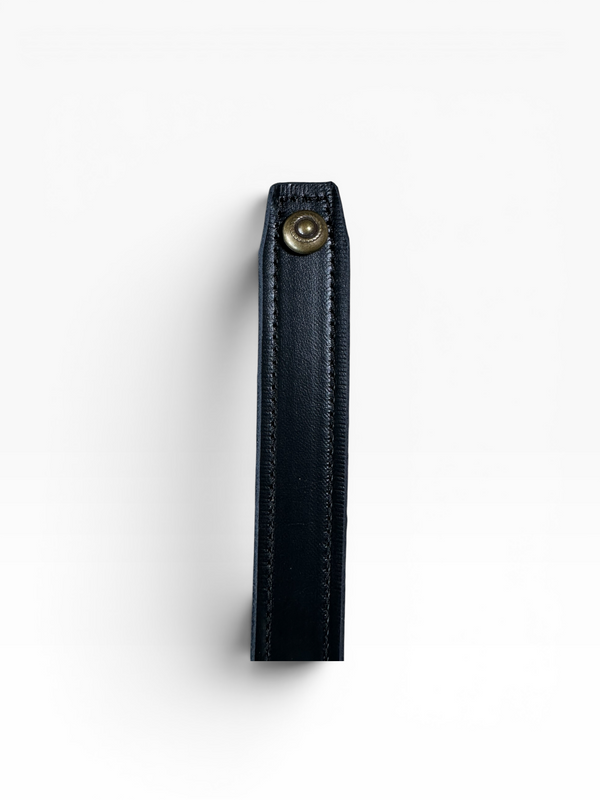 A close-up of a dark navy leather strap or sleeve with a brass snap button closure, shown vertically against a plain white background.