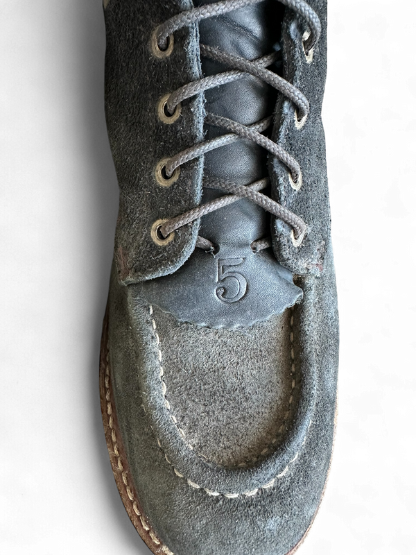 Black boot zoomed in on laces with transparent background