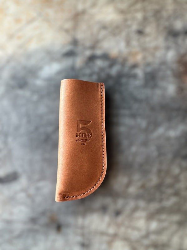 Brown leather skillet sleeve on cutting table