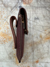 Brown leather knife sheath side profile on a textured surface
