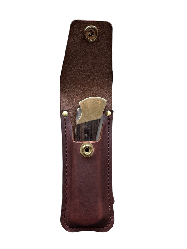 Brown leather sheath with brass clip on a white background