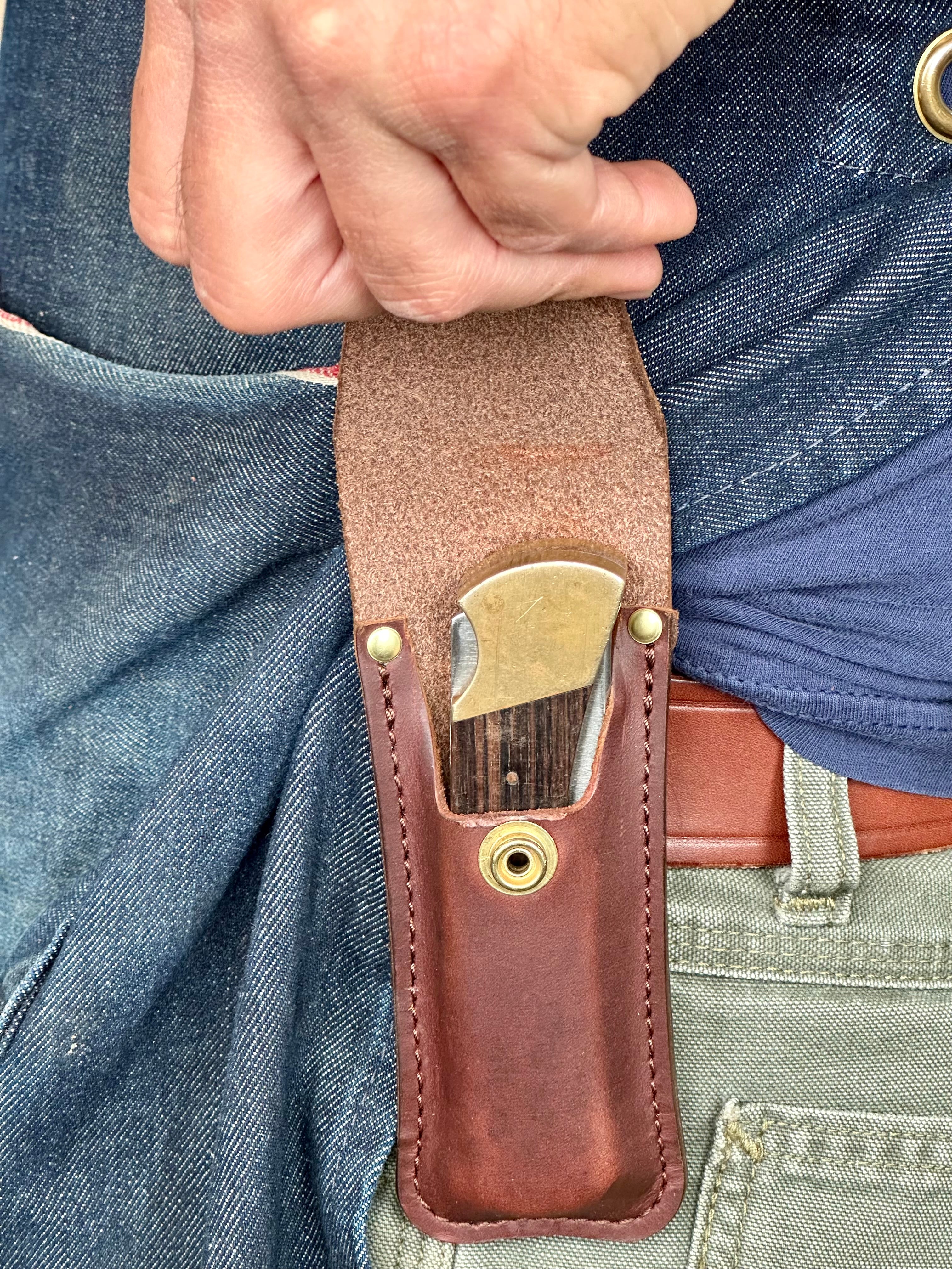 Knife sheath worn on a person's belt with with hand opening sheath