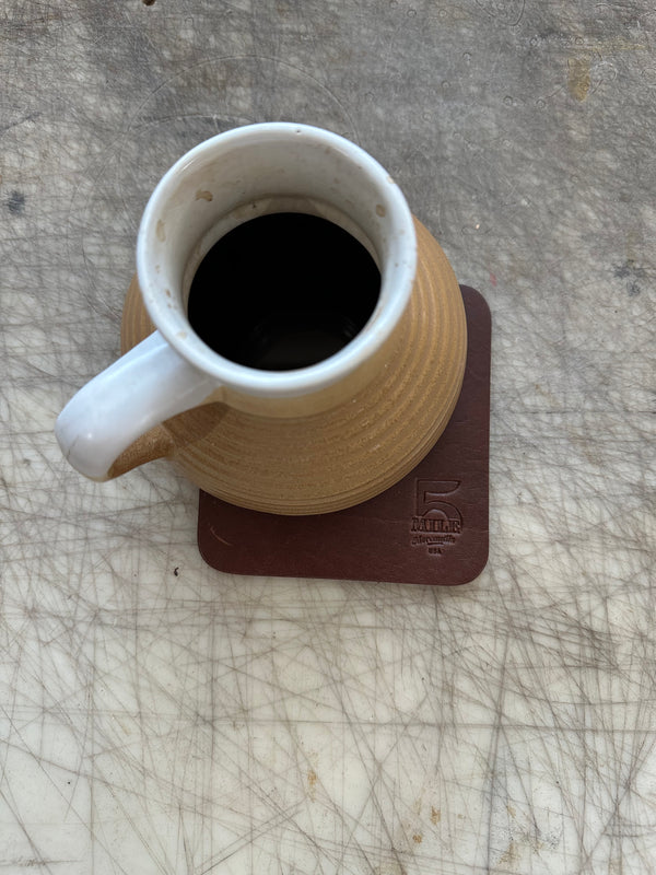 Coaster with coffee mug on cutting table