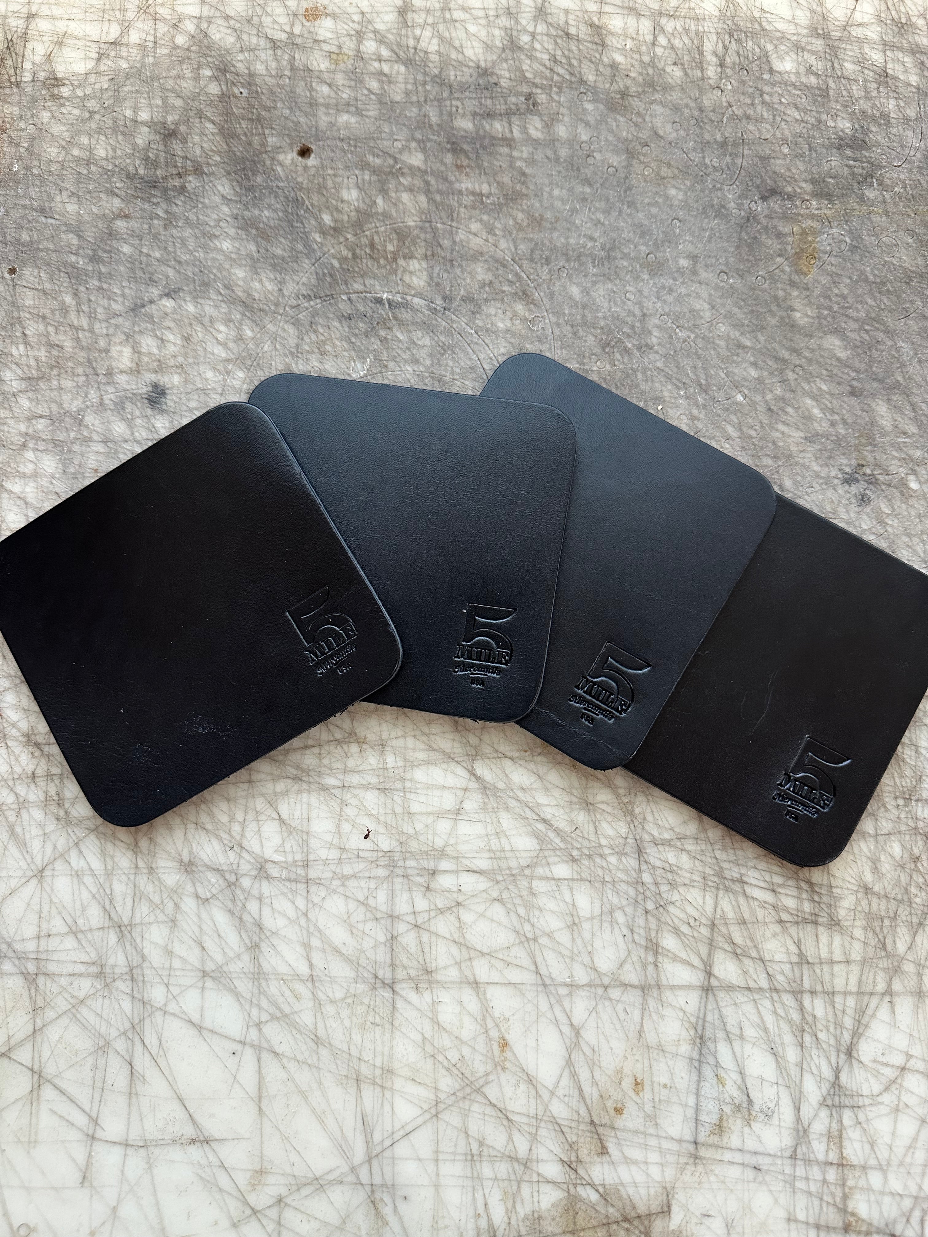 Coasters Black on cutting table