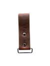 Brown leather strap with metal buckle on a white background