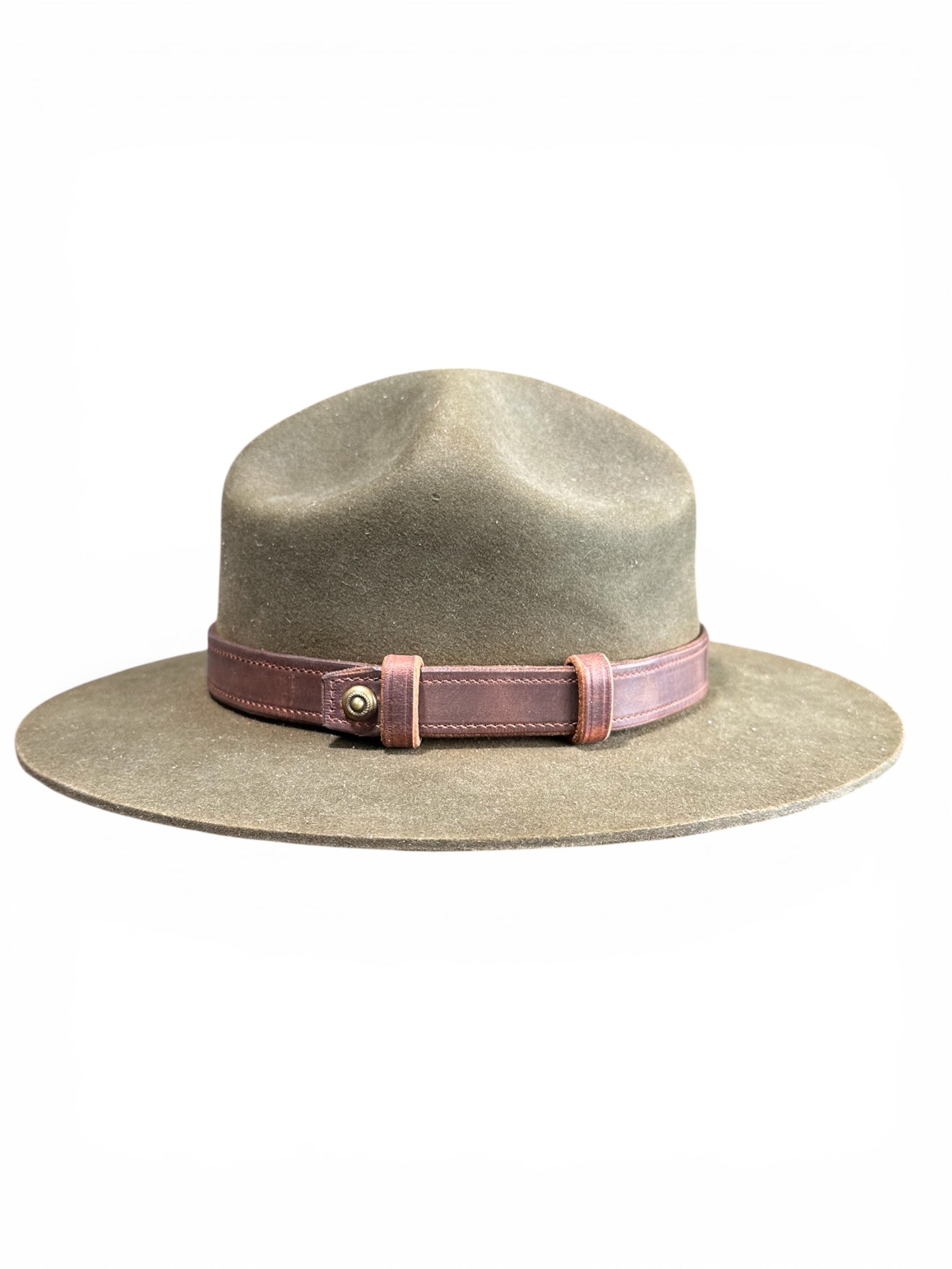A wide-brimmed felt hat in a muted taupe-gray color, featuring a dusty rose pink leather band with a gold-tone metal snap closure, set against a plain white background.