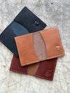 Folding card wallets brown, black, and coffee on cutting table