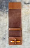 Brown leather pencil case with a pen on a textured surface
