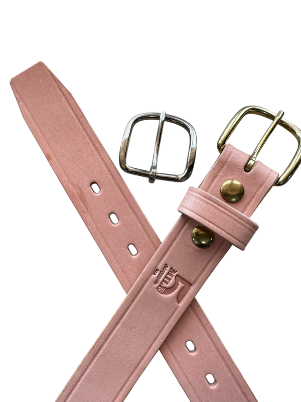 Pink leather belt with gold and silver buckles on a white background