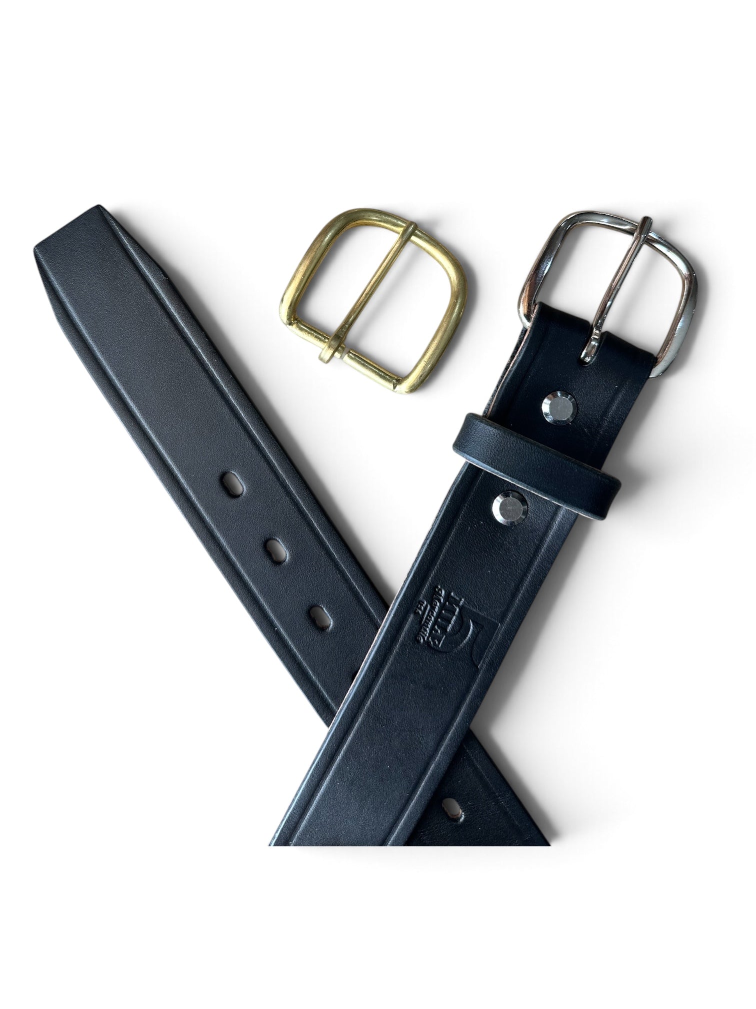 A black leather belt shown on a clean white background, accompanied by a gold-toned brass buckle and a silver-toned metal buckle.