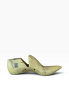 A single carved wooden shoe tree or foot mold shown on a plain white studio background. The item appears light tan to pale yellow wood with some darker brown grain and small dark markings on the left side.