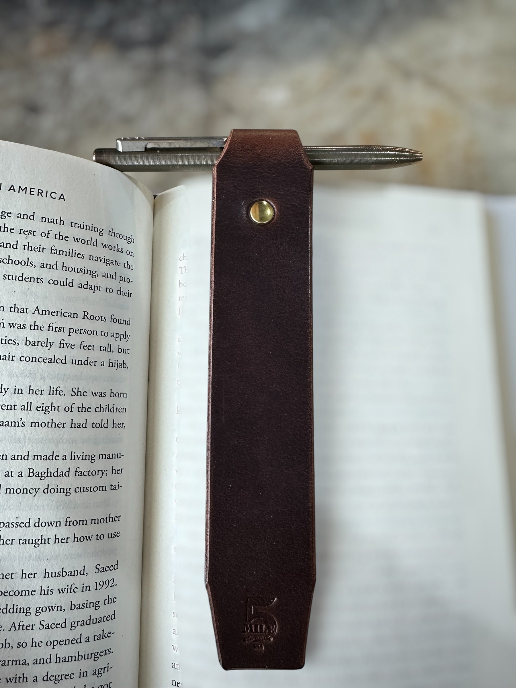 Leather bookmark in book on cutting table