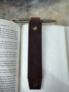 Leather bookmark in book on cutting table