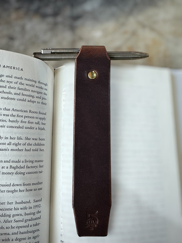 Leather bookmark in book on cutting table