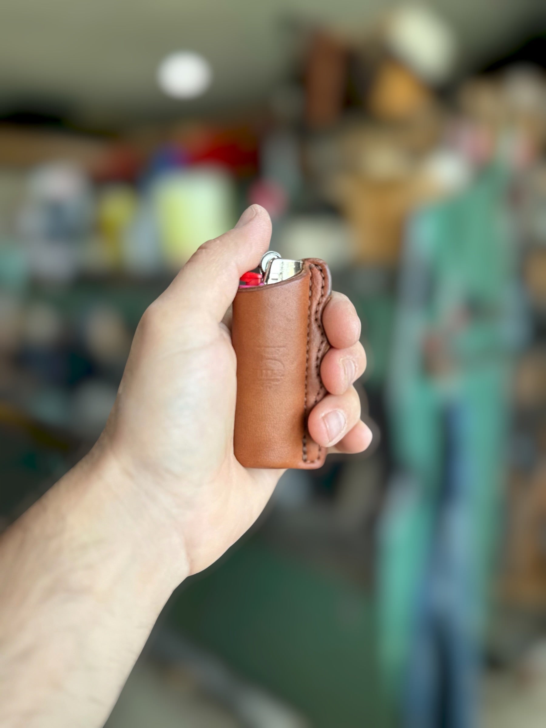 Leather lighter sheath with finger grooves in hand