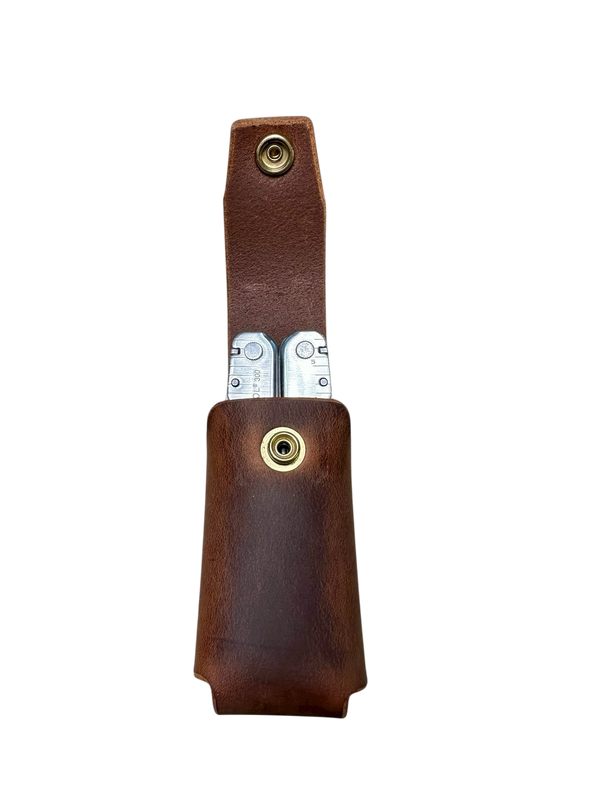 Brown leather case with a silver knife inside on a white background