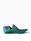 A single teal green wooden shoe tree with a textured finish and a small printed logo on the side, photographed against a clean white background.