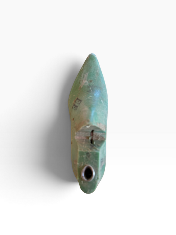 A single small pointed turquoise-green bead or pendant with a hole near the bottom, shown on a plain white background.