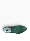 A single wooden shoe tree foot with a distressed green finish and a weathered silver metal cap on the heel, shown from a top-down view on a white background.