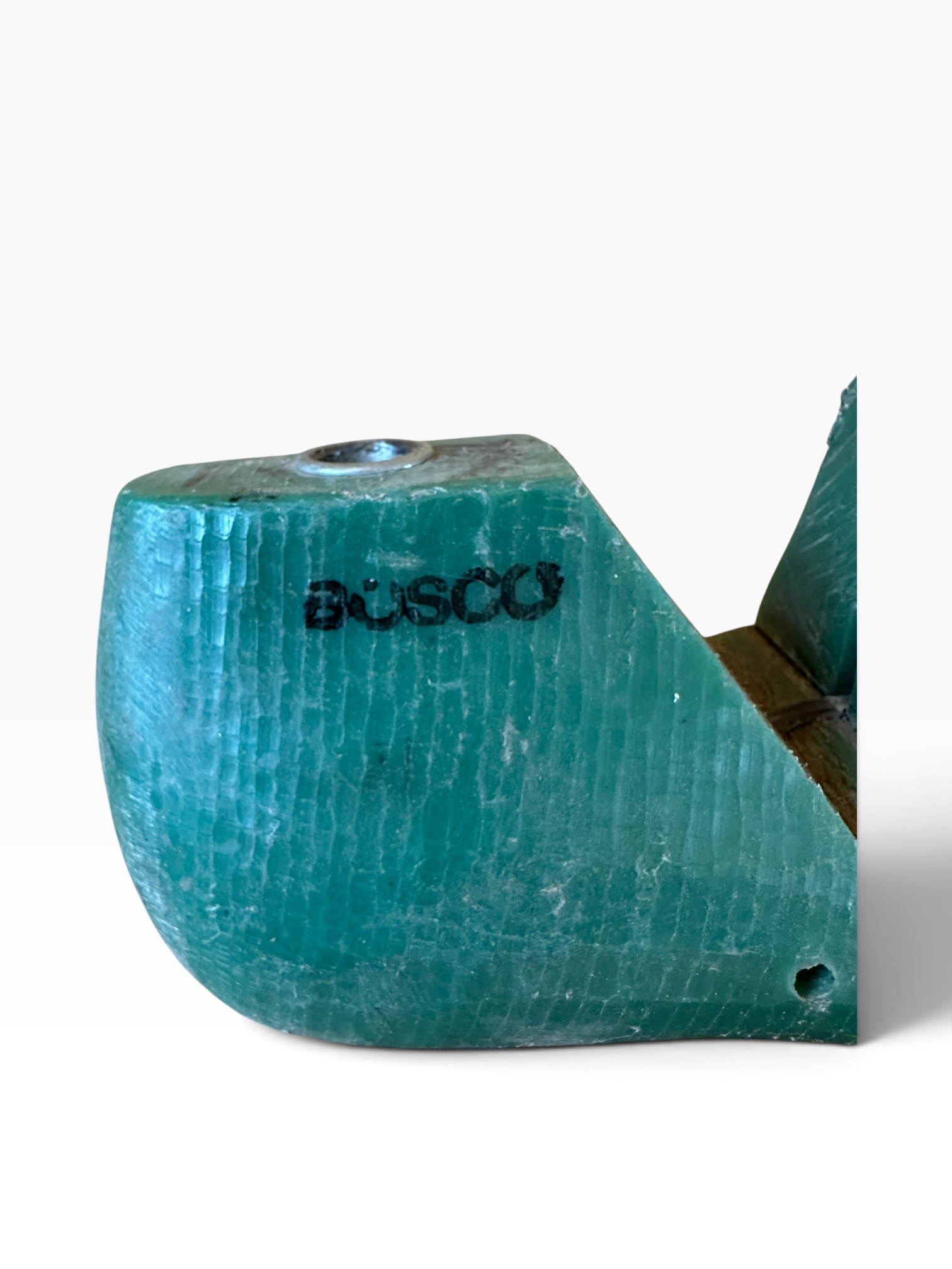 A turquoise blue textured plastic or resin object with the word 'BOSCO' printed in black on the front, photographed on a plain white background.