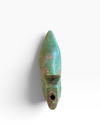 An antique-style green ceramic pipe or wind instrument with a weathered patina, shown against a plain white background.