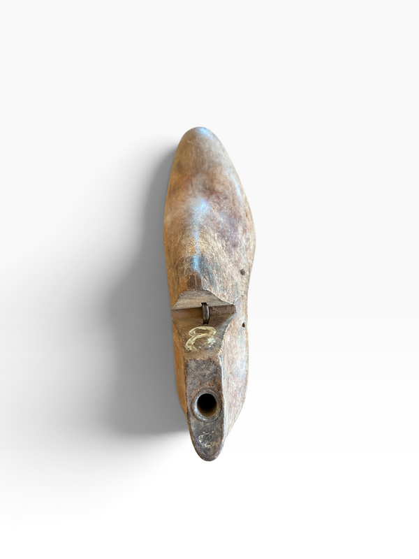 A single rustic wooden shoe tree with a natural weathered finish, shown vertically against a plain white background.