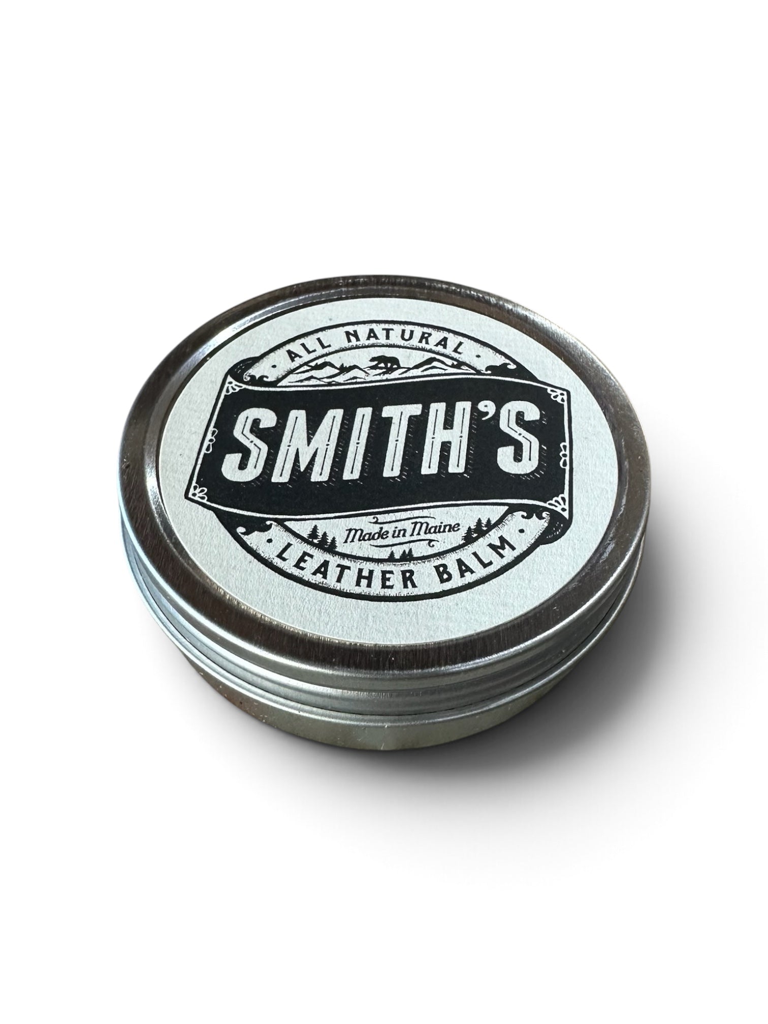A round metal tin of Smith's Leather Balm with a white and black label, shown on a clean white background with a soft shadow.