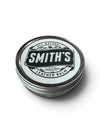 A round metal tin of Smith's Leather Balm with a white and black label, shown on a clean white background with a soft shadow.