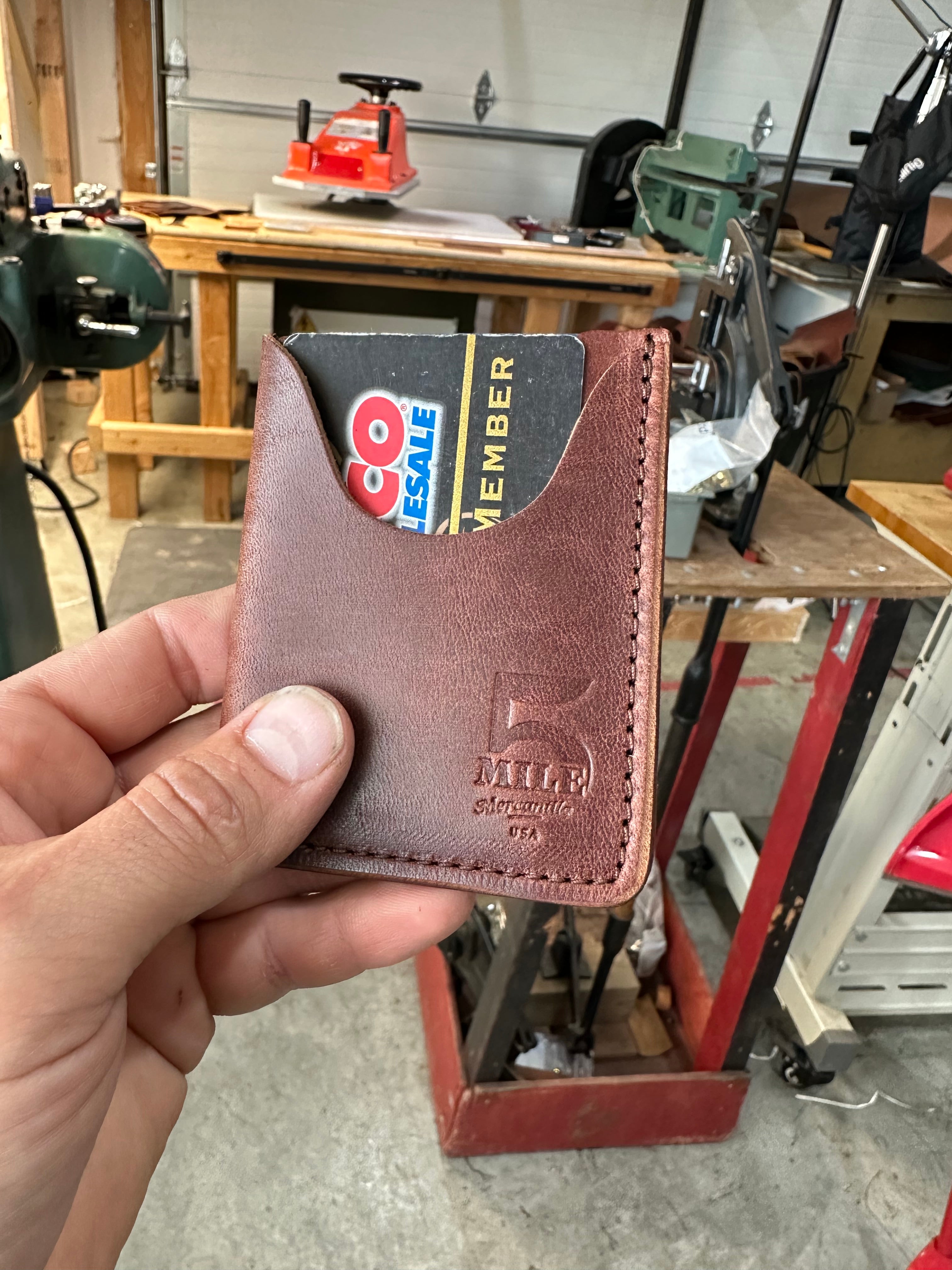 Vertical Card Wallet in hand with card in slot