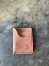 Brown leather wallet with a brand logo on a textured surface